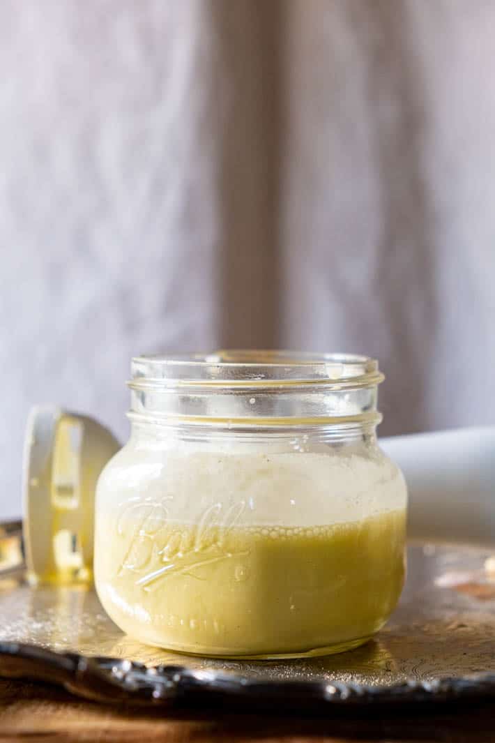 Emulsified caesar salad dressing in low Ball mason jar.