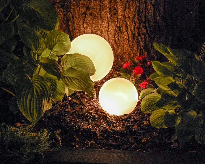 Glowing outdoor orbs at night.