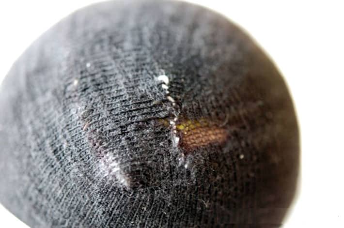 How to darn a sock. Black sock darned to close up hole from wear.