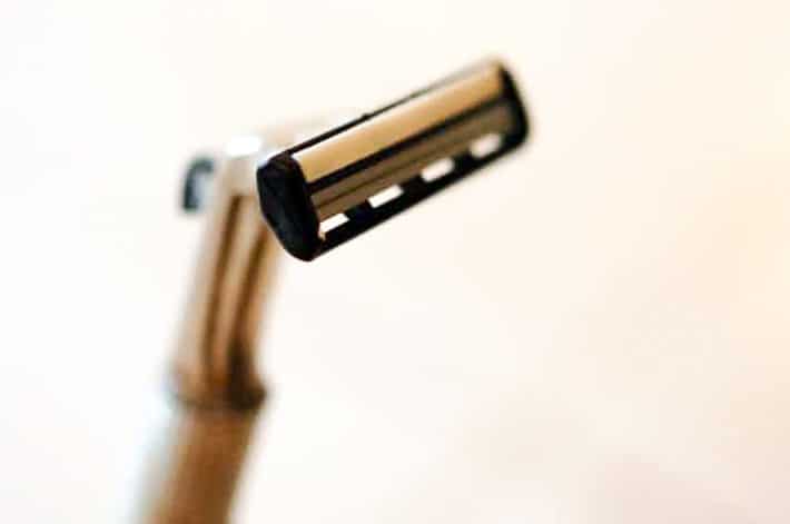 Men's stainless steel razor with a double blade razor head in it.