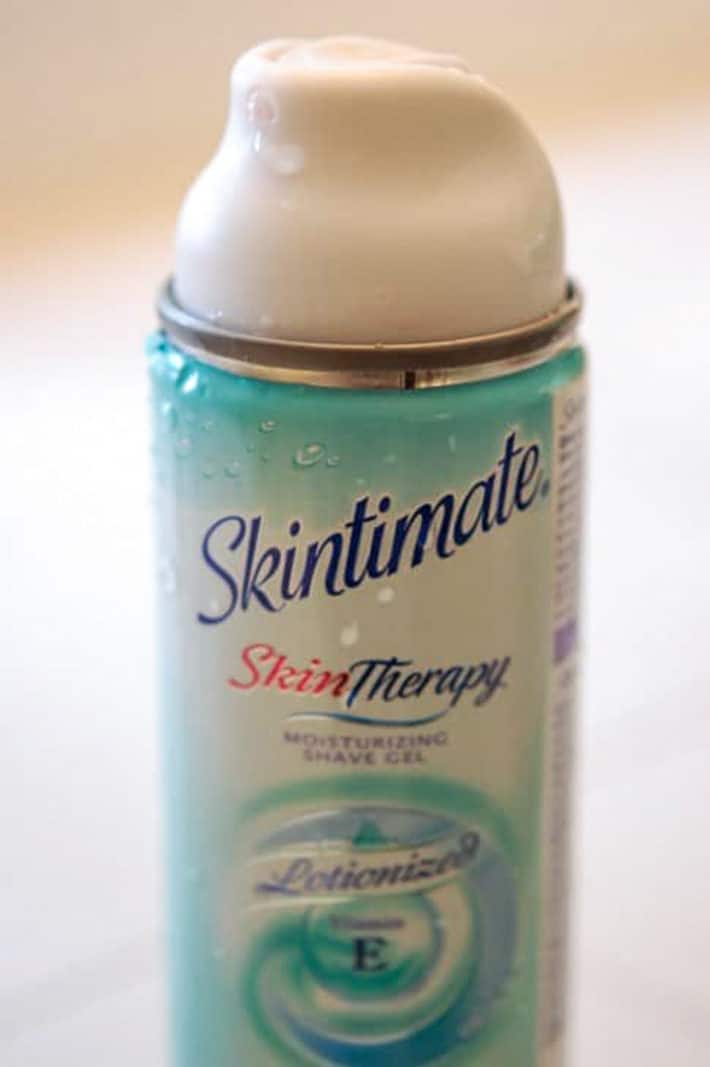 Blue and white metal can of Skintimate shaving cream.
