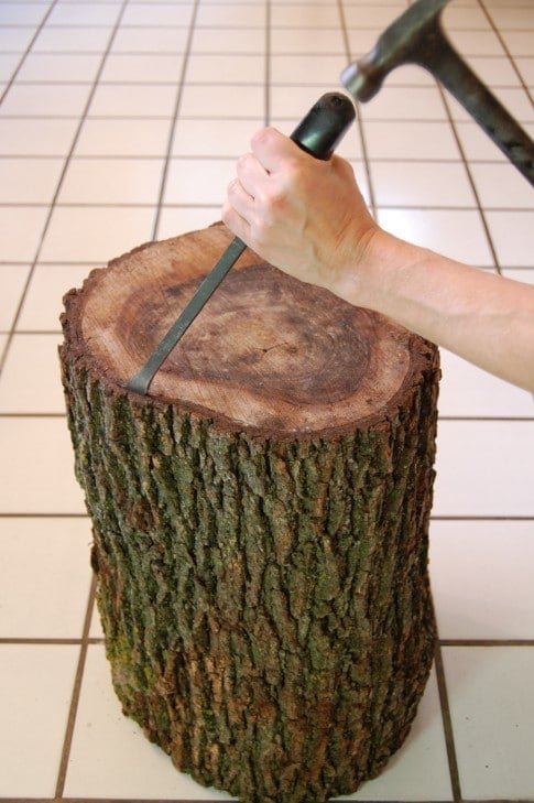 Chiselling bark off of tree trunk for side table.
