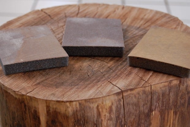 Sandpaper blocks on top of tree stump