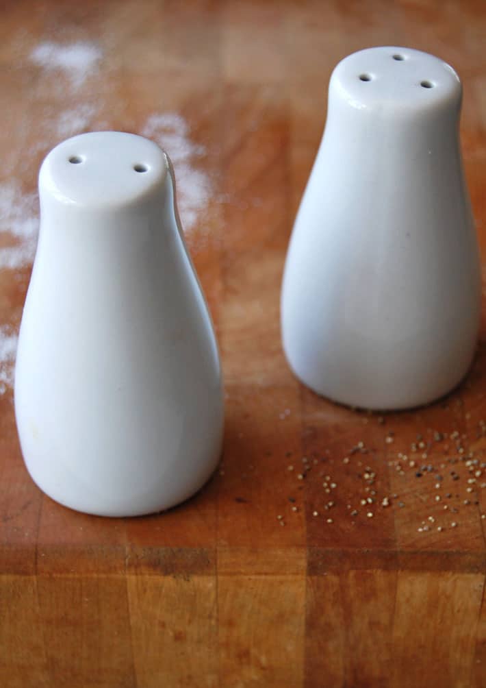 The salt and pepper rule. Which goes in which shaker? Contemporary, white, sleek ceramic salt and pepper shakers.