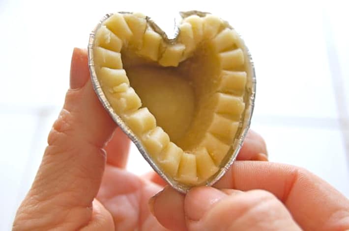 Finishing shaping heart shaped tart by pulling bottom into point.