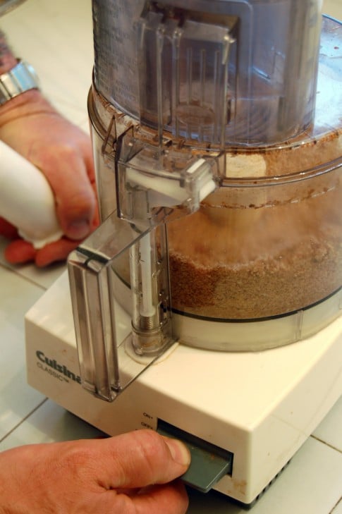Food Processor being pulsed to produce a flour made from nuts.