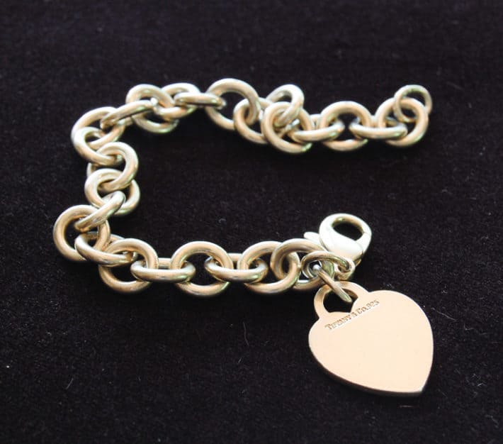 After picture of silver bracelet with heart charm post cleaning with silver dip.