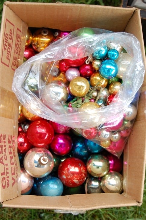 A big box of balls.  If they're unique, antique/vintage Christmas balls are expensive.  The regular old round variety however are fairly inexpensive.  This whole cardboard box filled with multicoloured glass Christmas balls was $10.