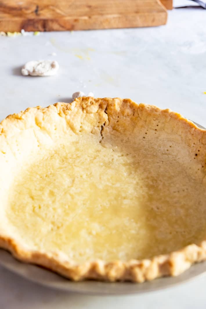 Blind baked pie crust with a crack.