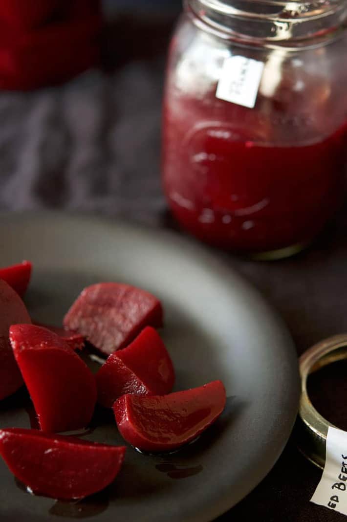 Red pickled beets on a plate.