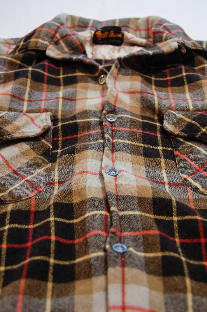 Flannel shirt with the front placket where the buttons are, sewn together.