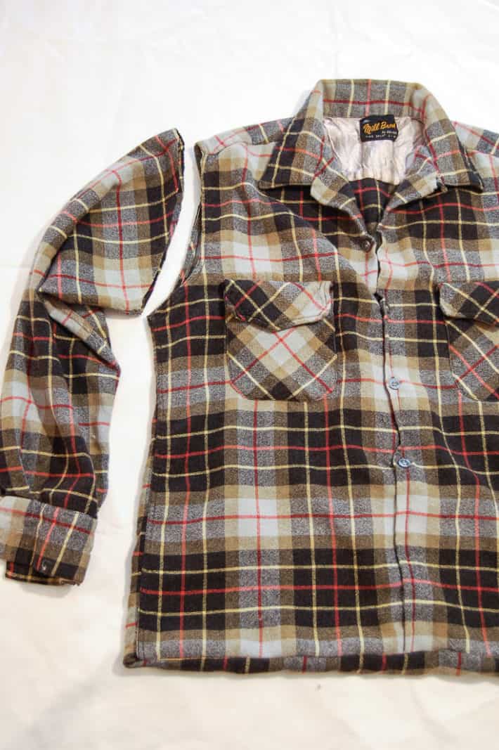 Flannel shirt with the right sleeve cut off.