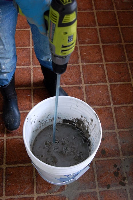 Mixing self leveling concrete in a bucket.