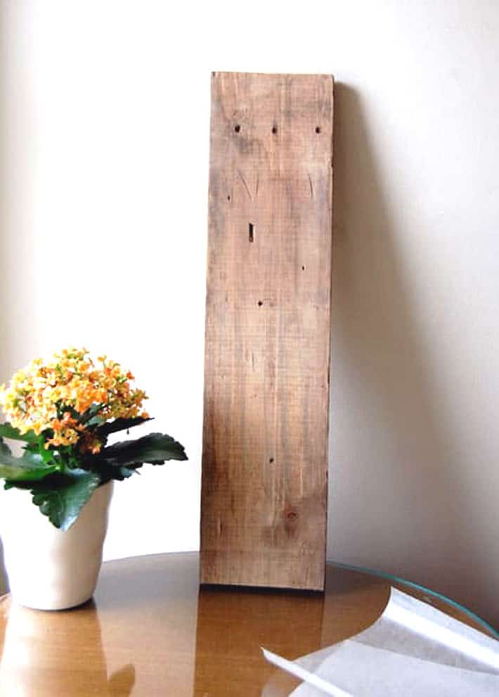 How to easily print on wood at home right now! Raw wood ready for printing propped against a white wall.