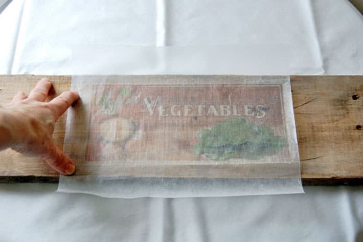 How to easily print on wood at home right now! Laying printed wax paper on piece of unfinished wood.