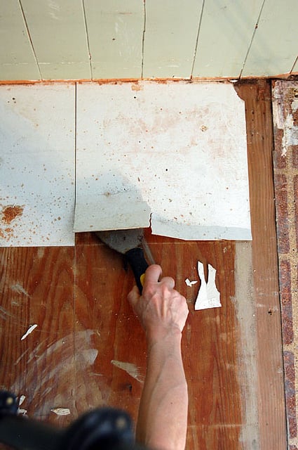 Scraping off stick down tiles.