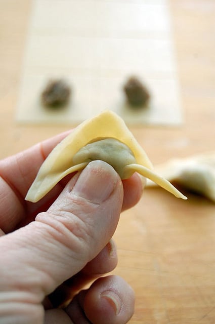 Close up shot of hand forming homemade tortellini.