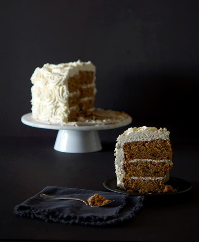 A three layer carrot cake with rose piped cream cheese frosting.