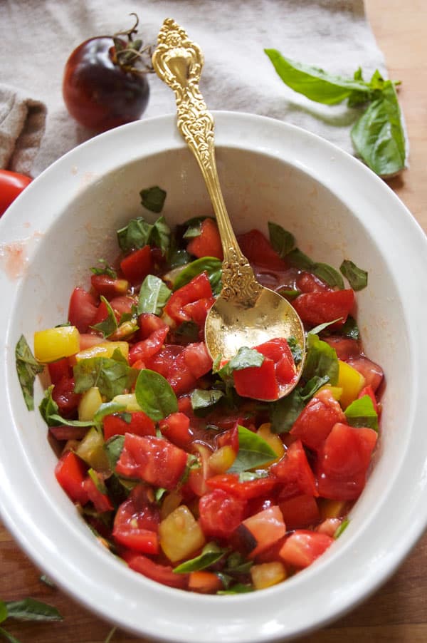 Diced tomatoes and basil marinating in olive oil for making bruschetta.