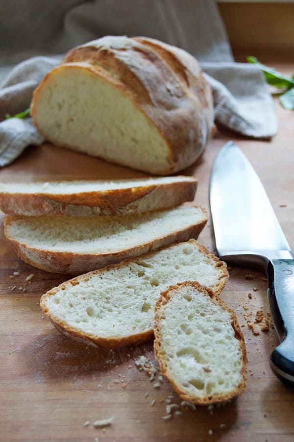 Homemade bread sliced into thick pieces for bruschetta.