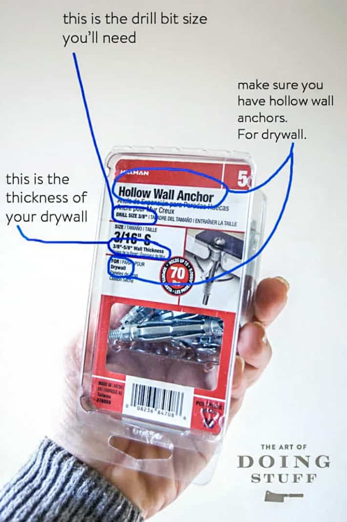 A hollow wall anchor box being held up, outlining all the important sizes and measurements you need to pay attention to when buying them.