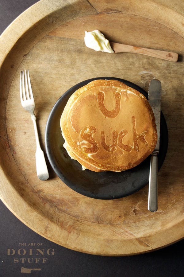 Pancakes with words "U suck"