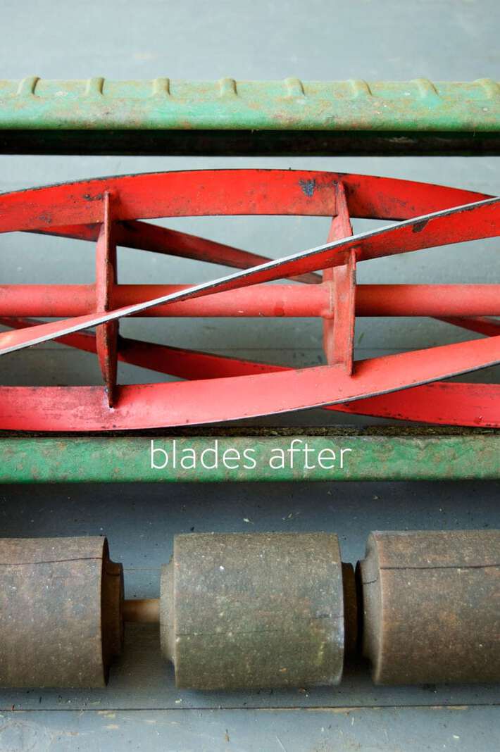 Shiny silver blades of a newly sharpened push mower.