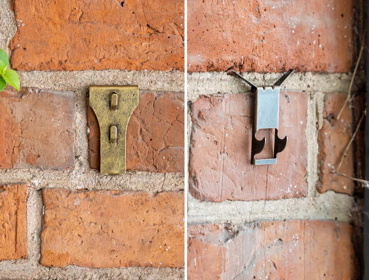 Two types of brick clips hanging on brick wall.