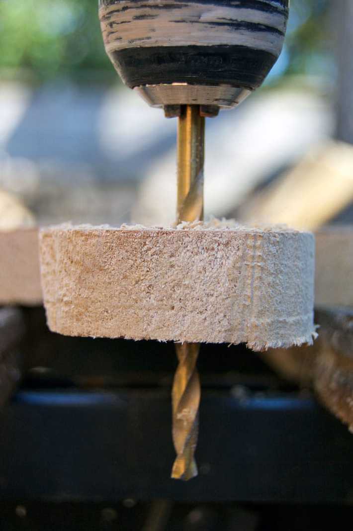 Drilling a hole into the end of a wood serving board to allow it to be hung.