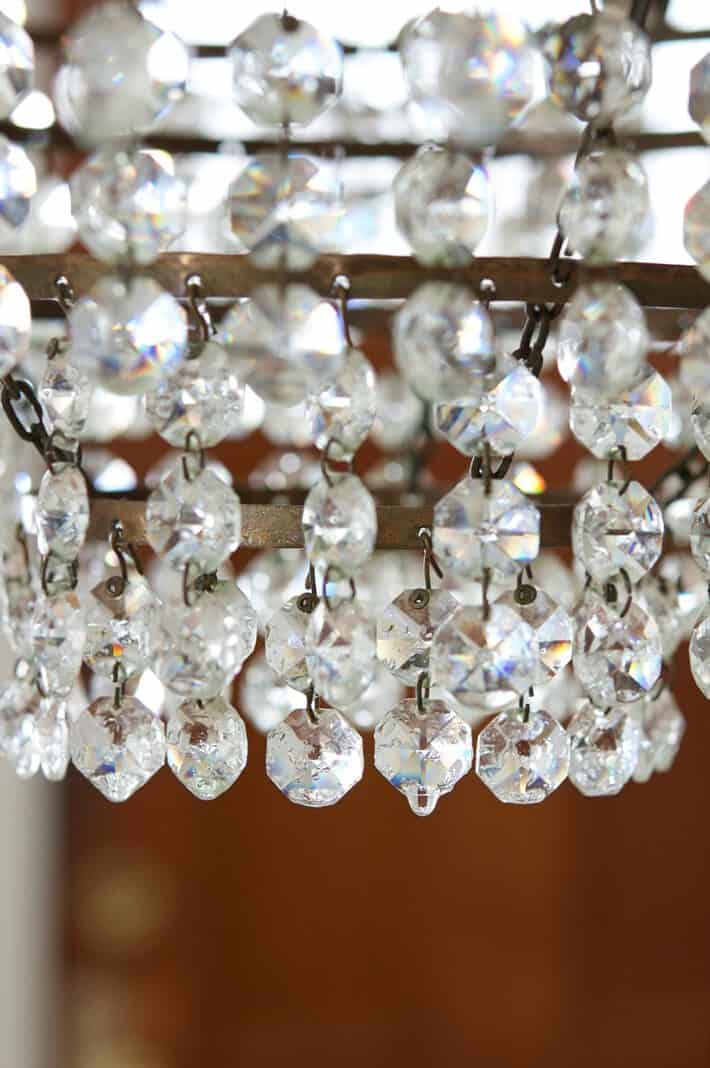 Spray cleaner drips off of a crystal chandelier.