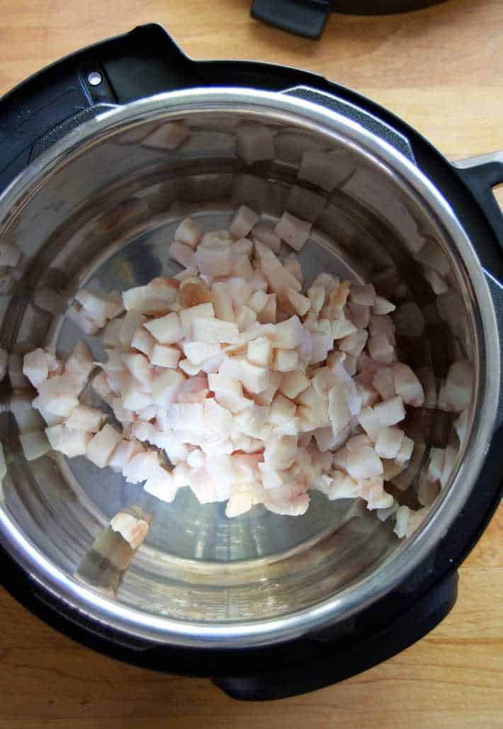 Diced pork fat in an Instant Pot, ready to render into lard.