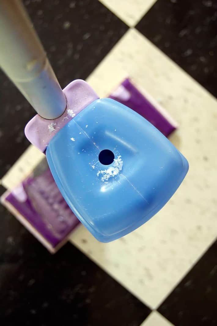 Close up shot of a blue Swiffer Wet Jet bottle with a newly drilled hole in the top.