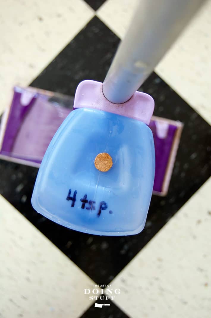 Overhead shot of Swiffer Wet Jet solution bottle with cork cap in it.