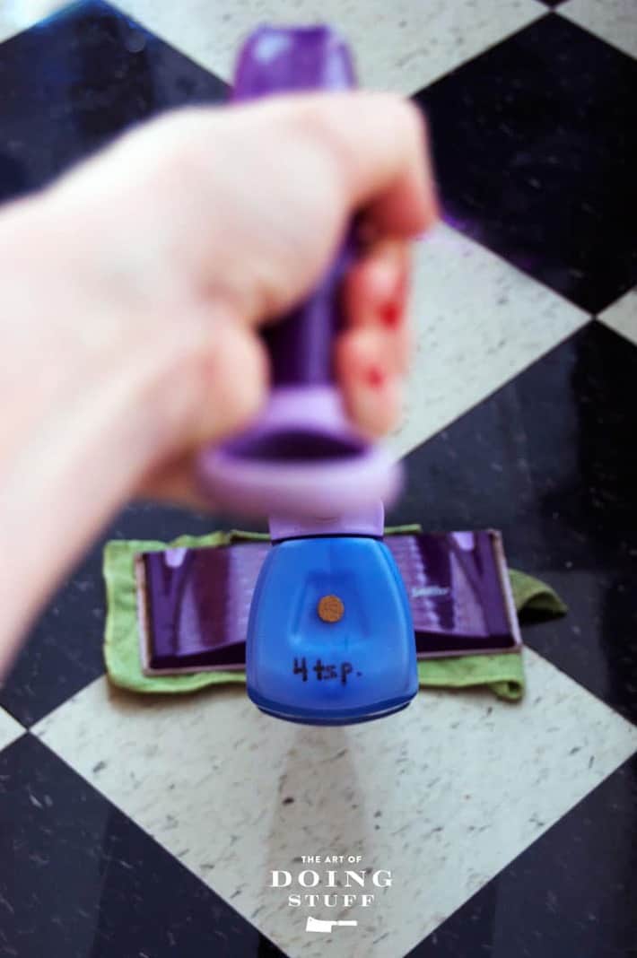 Swiffer Wet Jet with a microfibre cloth as a pad and a hole with a cork in the top for refilling with cleaning solution.