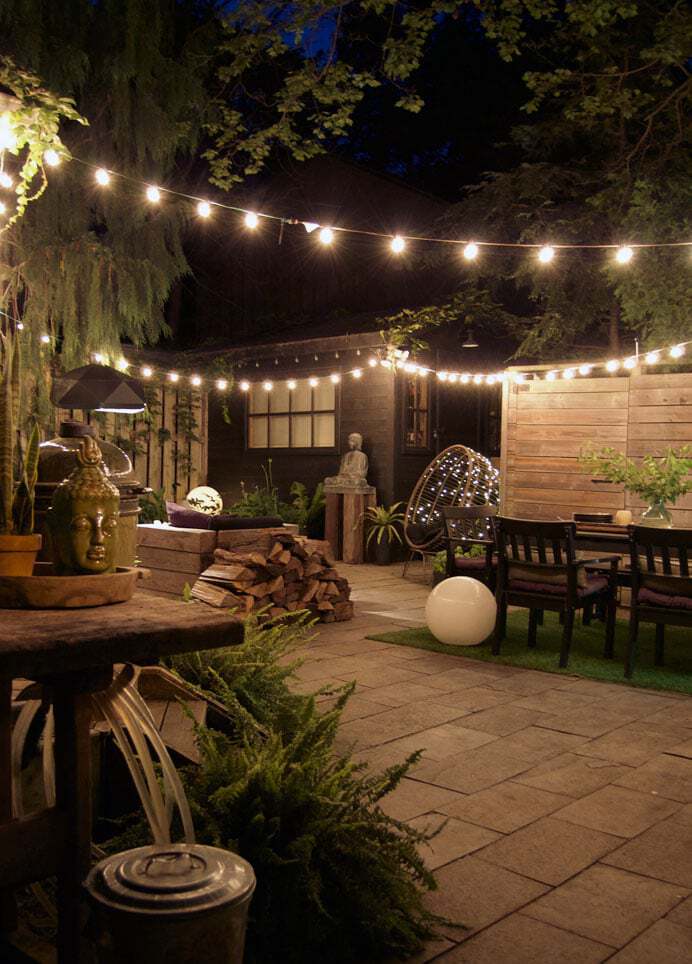 Courtyard backyard with square cut flagstone and a variety of innovative lighting.