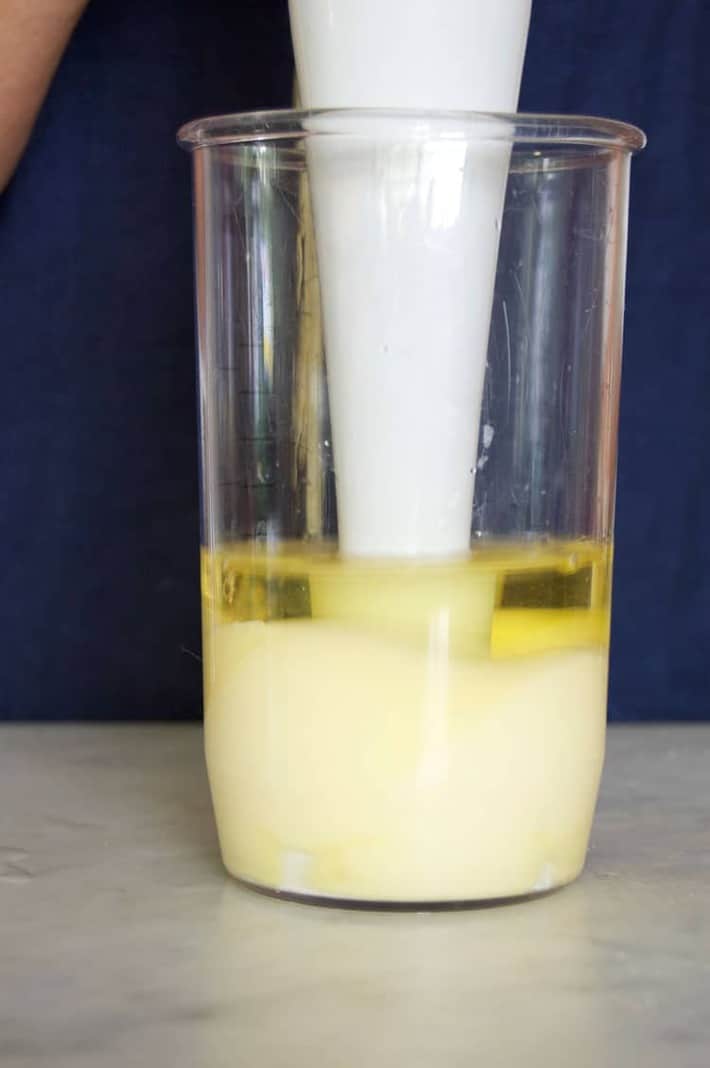 Homemade mayonnaise being blended with immersion blender.