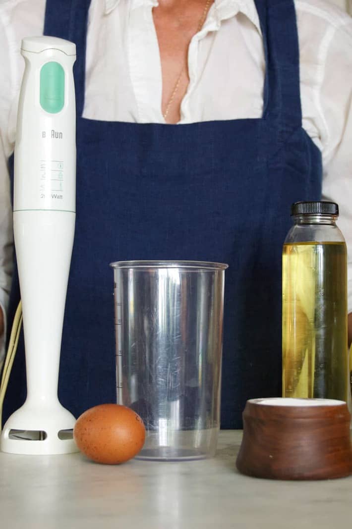 Homemade mayonnaise ingredients laid out with immersion blender to the side.