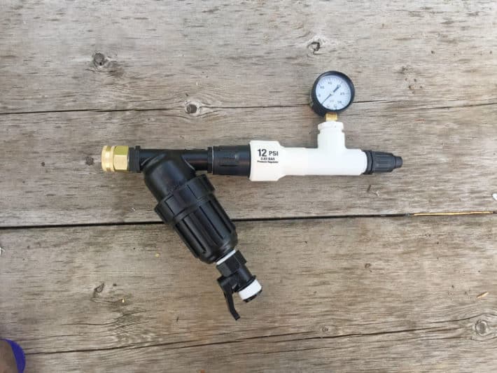 A fully assembled filter and pressure reducer on a home drip irrigation system.