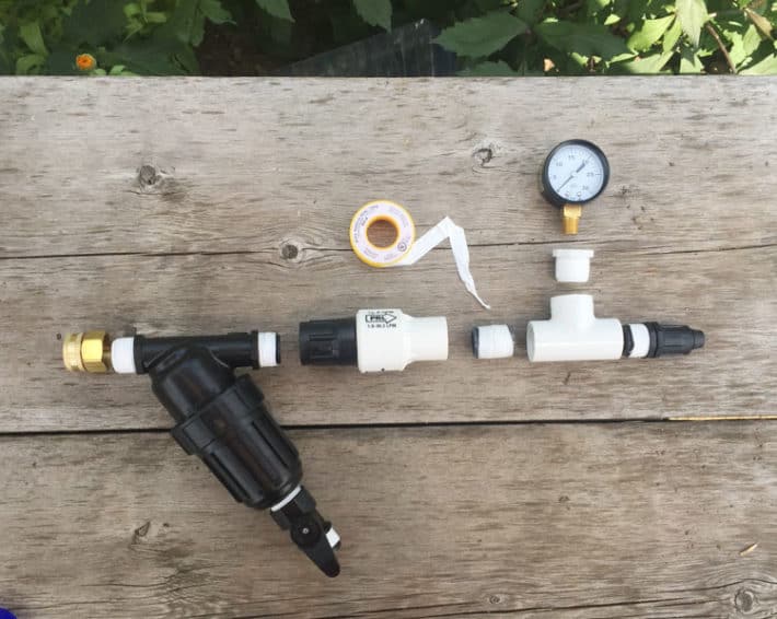 Assembling the filter and pressure reducer on a drip irrigation system showing which threads to apply plumbing tape to.