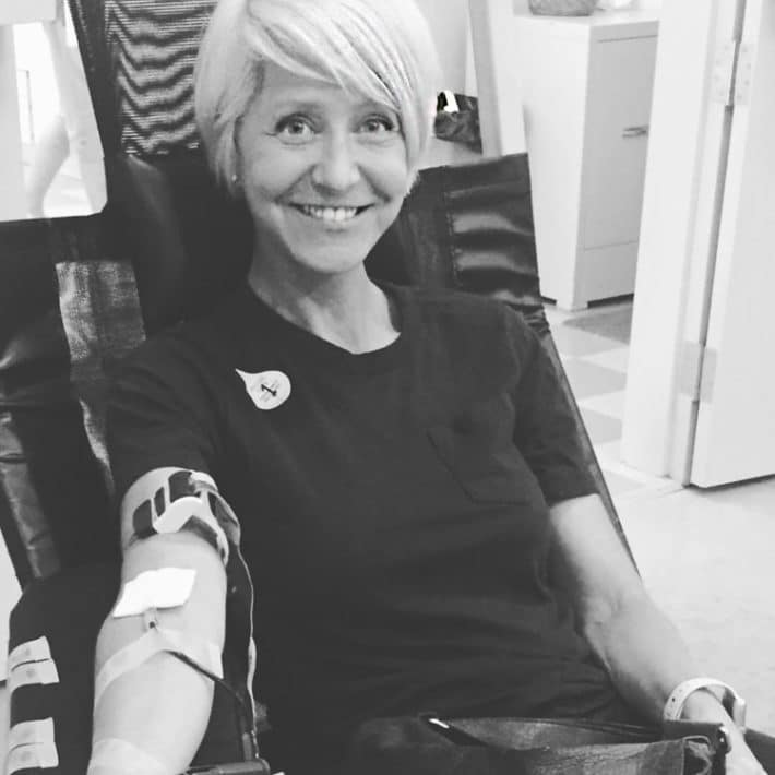 Karen Bertelsen sits comfortably in a chair, donating blood.