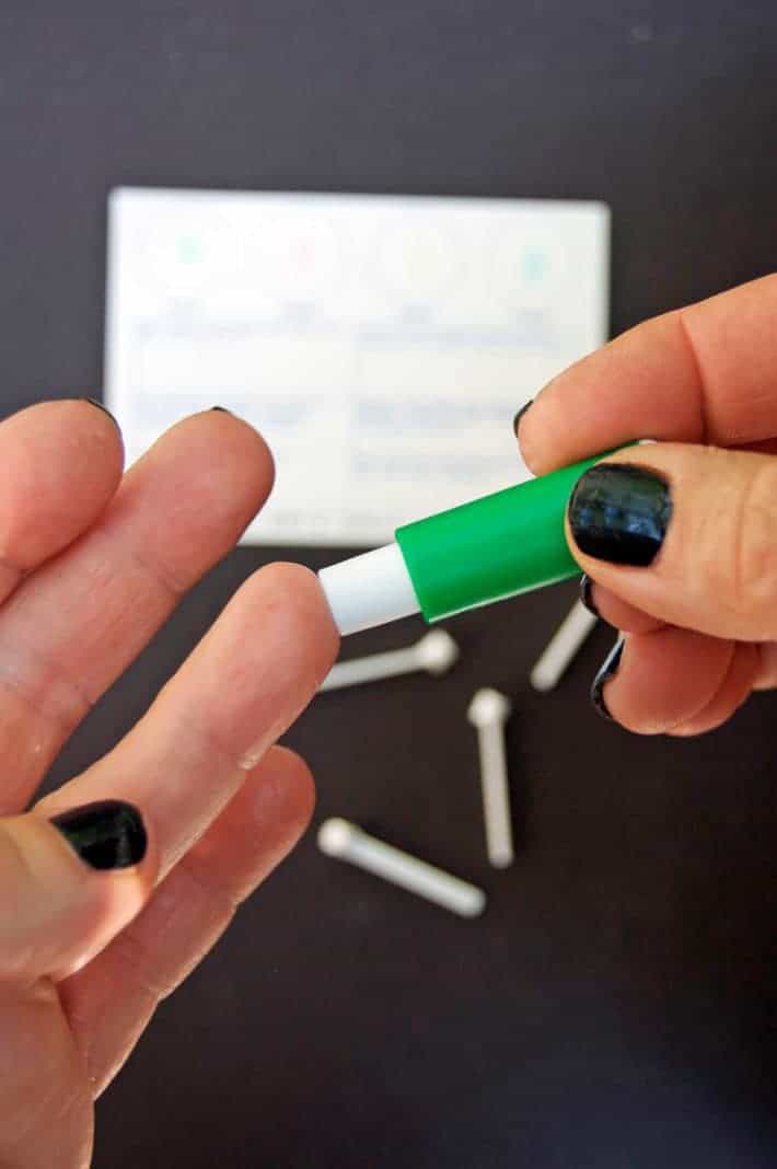 Pricking tip of ring finger with a lancet to test blood type.