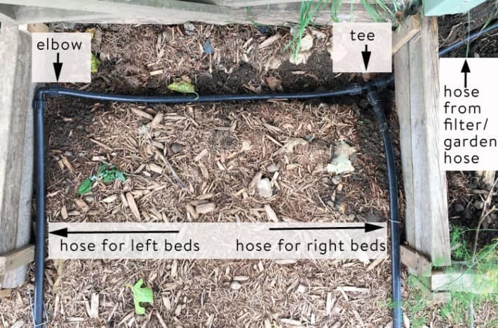 Overhead view of various joined sections of drip irrigation tubing around corners.