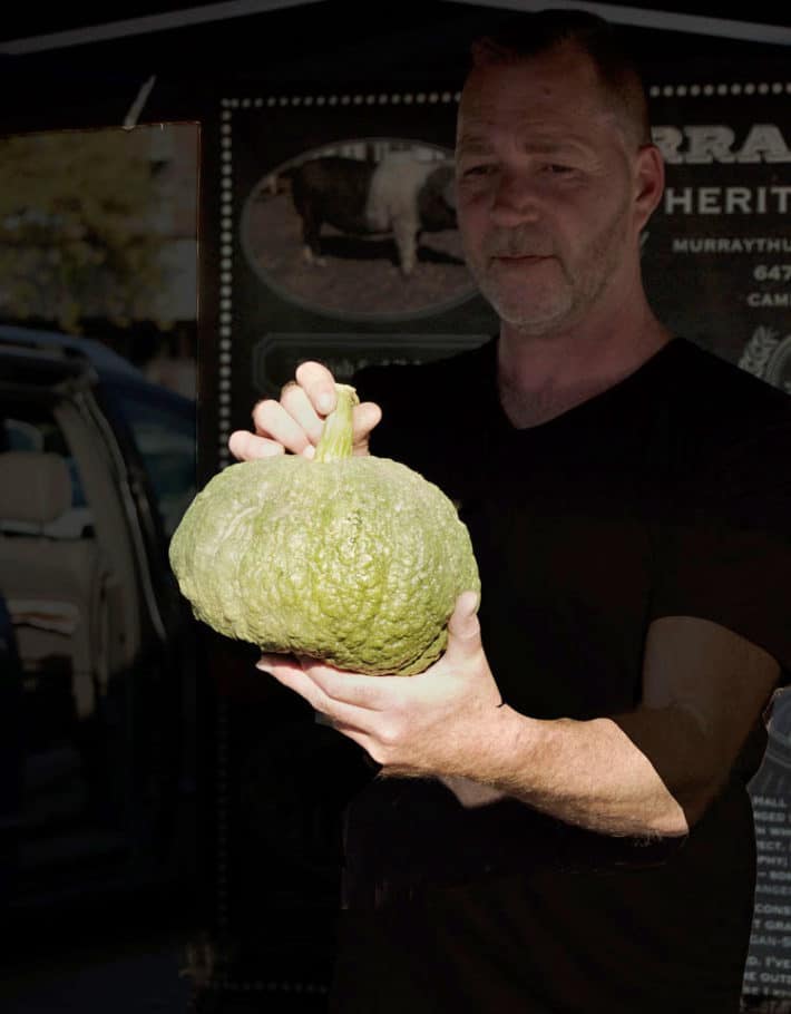 Murray Thunberg pig farmer with squash.