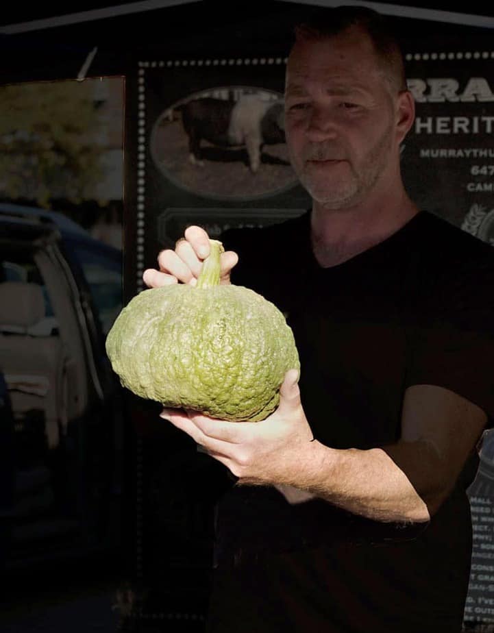 Murray Thunberg, farmer, holding squash.