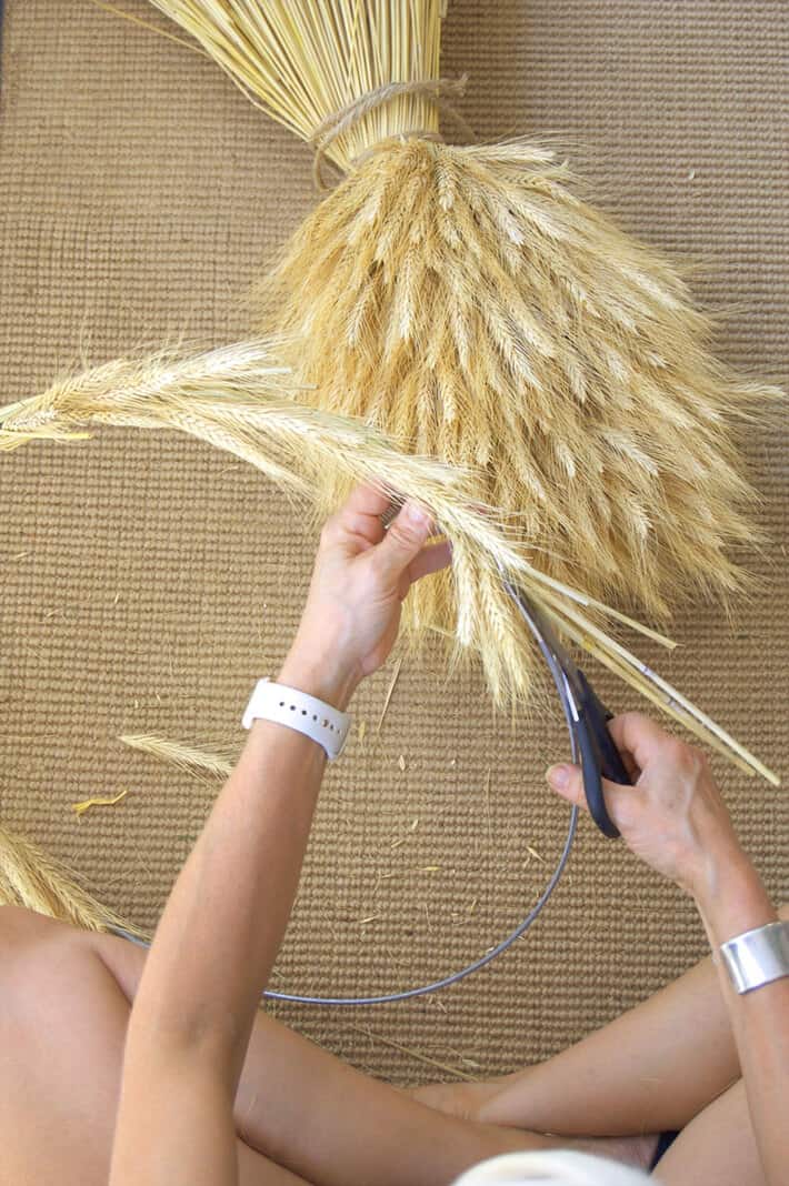Trimming off wheat stalks on homemade wheat wreath.