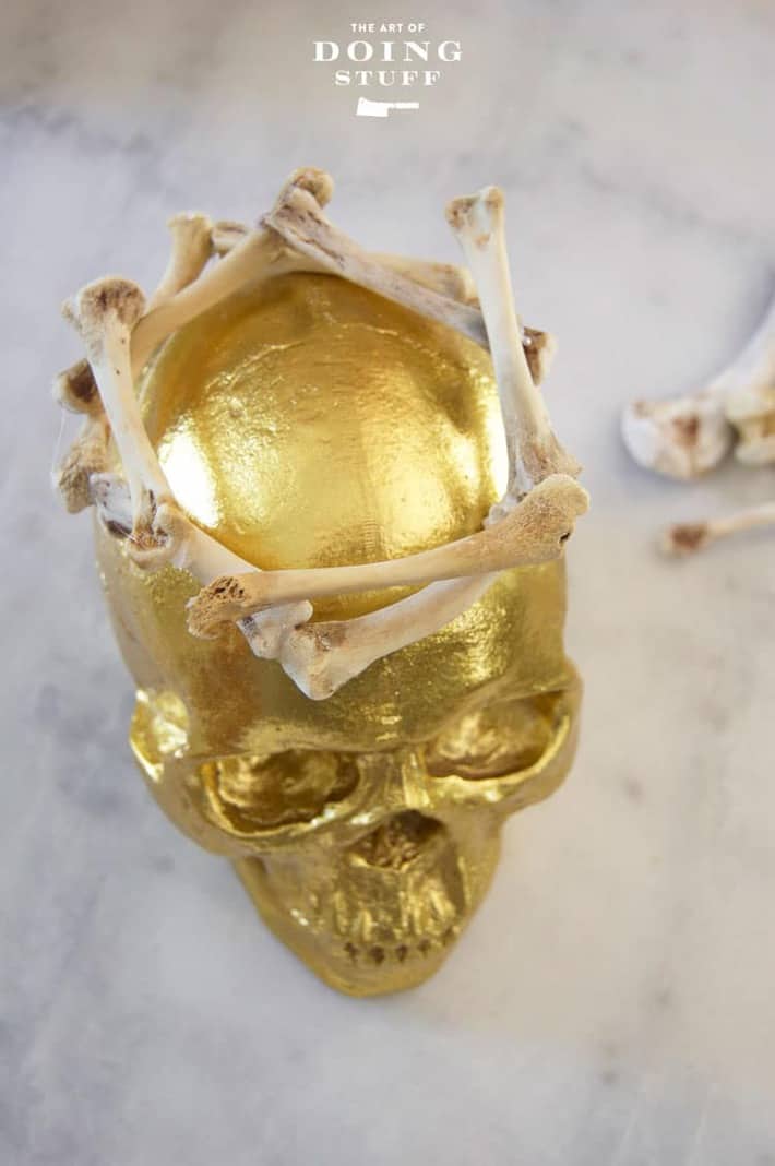 A gold Halloween skull on a marble table.