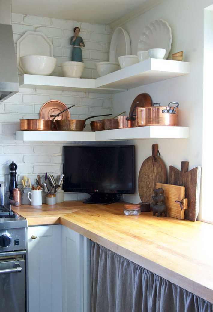 How to maintain and erase stains from butcher block countertops. Newly oiled butcher block countertop with vintage cutting boards leaning against backsplash.
