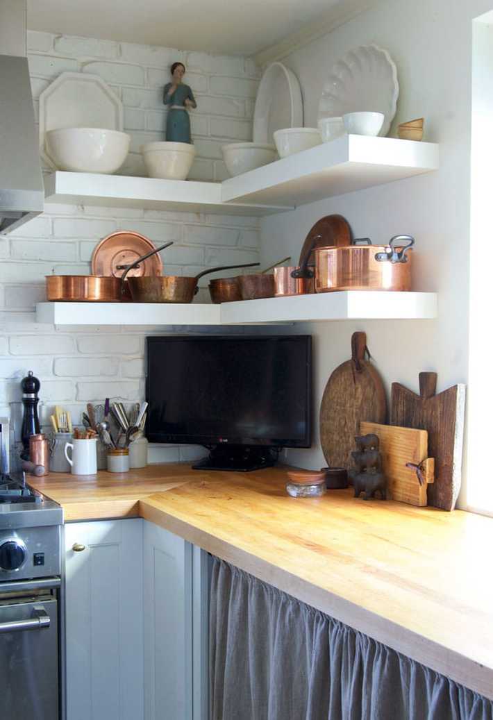 Newly oiled butcher block countertop with vintage cutting boards leaning against backsplash.