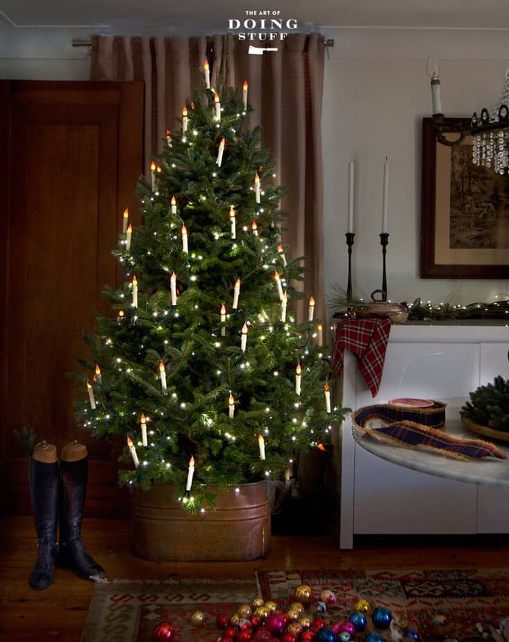 Fully lit Christmas tree with DIY flameless tree candles in English inspired cottage.