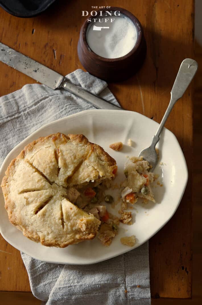 Delicious turkey pot pie in a flakey crust served on antique ironstone plate.